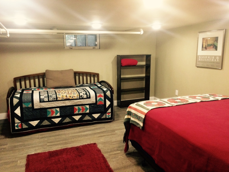 Bedroom with bed and trundle next to each other